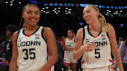 Dec 7, 2024; Brooklyn, New York, USA; Connecticut Huskies guard Azzi Fudd (35) and Connecticut Huskies guard Paige Bueckers (5) celebrate after the game against the Louisville Cardinals at Barclays Center. Mandatory Credit: Lucas Boland-Imagn Images