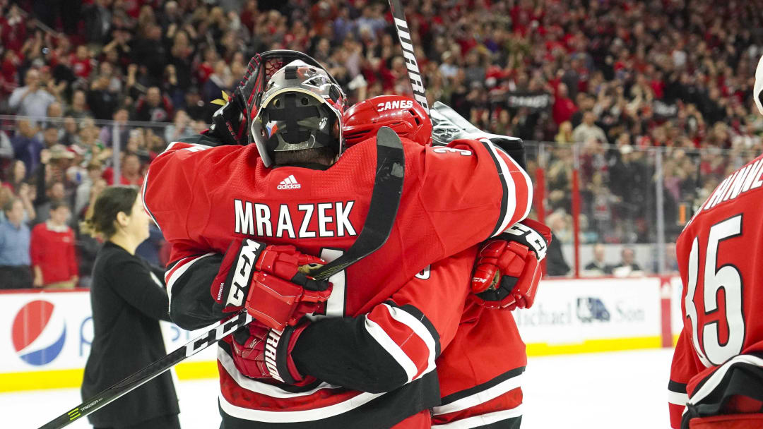 Apr 4, 2019; Raleigh, NC, USA;  Carolina Hurricanes goaltender Petr Mrazek (34) and center Sebastian Aho (20) celebrate their win against the New Jersey Devils at PNC Arena. The Carolina Hurricanes defeated the New Jersey Devils 3-1. Mandatory Credit: James Guillory-USA TODAY Sports