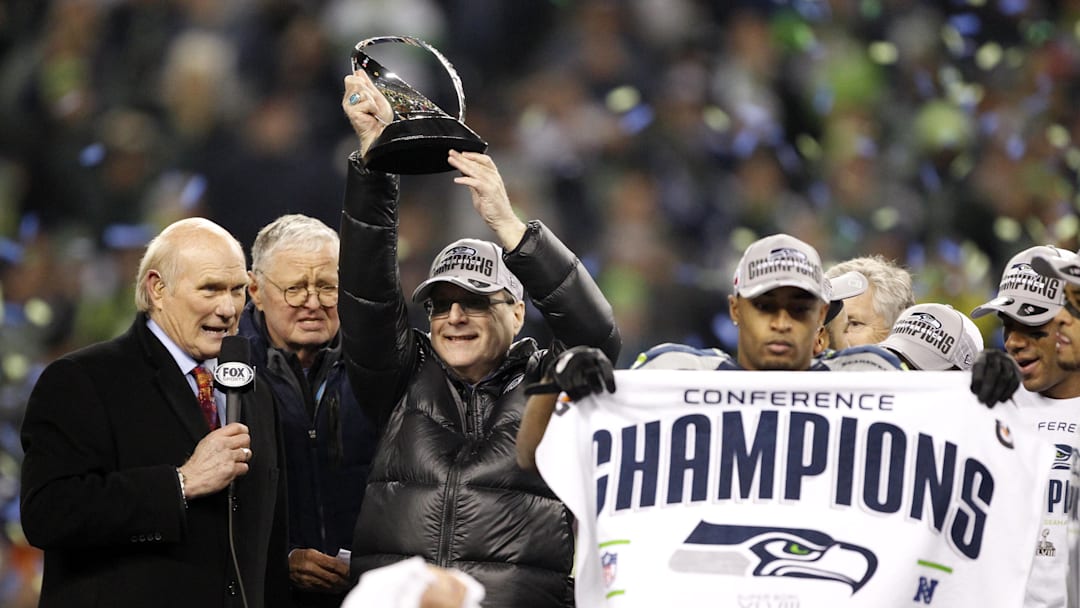 Jan 19, 2014; Seattle, WA, USA; Seattle Seahawks owner Paul Allen hoists the George Halas Trophy after the 2013 NFC Championship football game against the San Francisco 49ers at CenturyLink Field. Mandatory Credit: Joe Nicholson-Imagn Images Jan 19, 2014; Seattle, WA, USA; Seattle Seahawks owner Paul Allen hoists the George Halas Trophy after the 2013 NFC Championship football game against the San Francisco 49ers at CenturyLink Field. Mandatory Credit: Joe Nicholson-Imagn Images