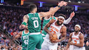New York Knicks center Mitchell Robinson grabs a rebound away from Boston Celtics forward Jayson Tatum. Mandatory Credit: Wendell Cruz-Imagn Images