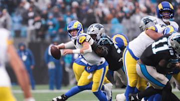 Nov 30, 2025; Charlotte, North Carolina, USA; Los Angeles Rams quarterback Matthew Stafford (9) is sacked by Carolina Panthers defensive end Derrick Brown (95) during the fourth quarter at Bank of America Stadium. Mandatory Credit: Scott Kinser-Imagn Images