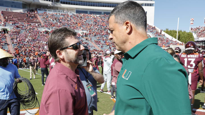 Oct 15, 2022; Blacksburg, Virginia, USA;  Miami Hurricanes head coach Mario Cristobal (right) greets