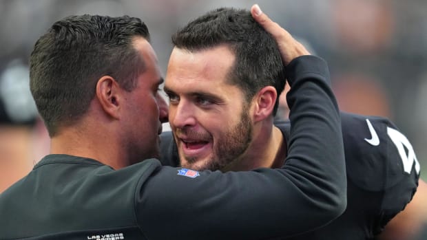 Raiders quarterback Derek Carr (4) is congratulated by General Manager Dave Ziegler after a win against the Houston Texans 