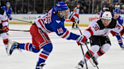 Oct 2, 2025; New York, New York, USA;  New York Rangers center Vincent Trocheck (16) attempts a shot defended by New Jersey Devils defenseman Topias Vilen (38) during the second period at Madison Square Garden. Mandatory Credit: Dennis Schneidler-Imagn Images