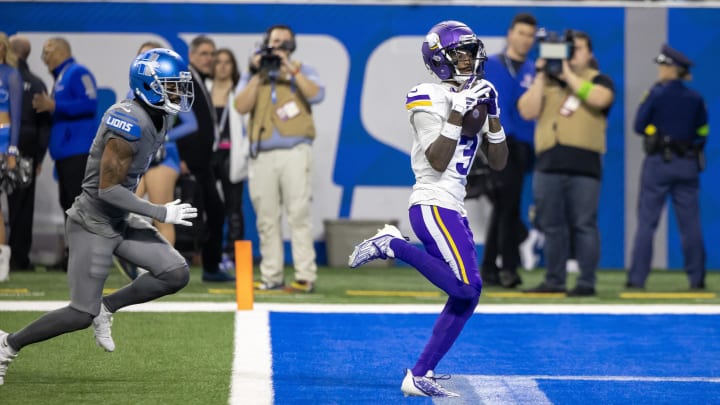 Jan 7, 2024; Detroit, Michigan, USA; Minnesota Vikings wide receiver Jordan Addison (3) catches a pass for a touchdown in front of Detroit Lions cornerback Cameron Sutton (1) during second half at Ford Field.