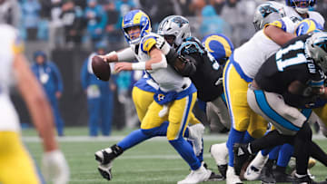 Nov 30, 2025; Charlotte, North Carolina, USA; Los Angeles Rams quarterback Matthew Stafford (9) is sacked by Carolina Panthers defensive end Derrick Brown (95) during the fourth quarter at Bank of America Stadium. Mandatory Credit: Scott Kinser-Imagn Images