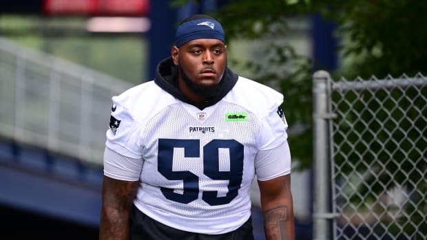  New England Patriots offensive tackle Vederian Lowe (59) walks to the practice field during training camp at Gillette.