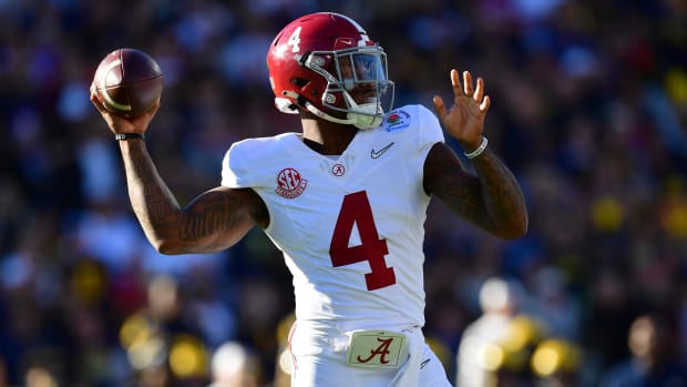 Alabama Crimson Tide quarterback Jalen Milroe attempts a pass during a college football game in the SEC.