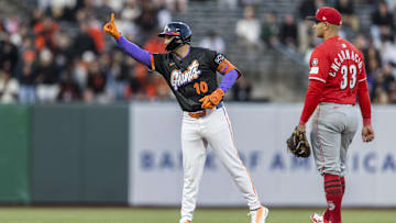 Apr 8, 2025; San Francisco, California, USA;  Cincinnati Reds first baseman Christian Encarnacion-Strand (33) watches as San Francisco Giants first baseman Casey Schmitt (10) gestures after he hit a double during the second inning at Oracle Park. Mandatory Credit: John Hefti-Imagn Images