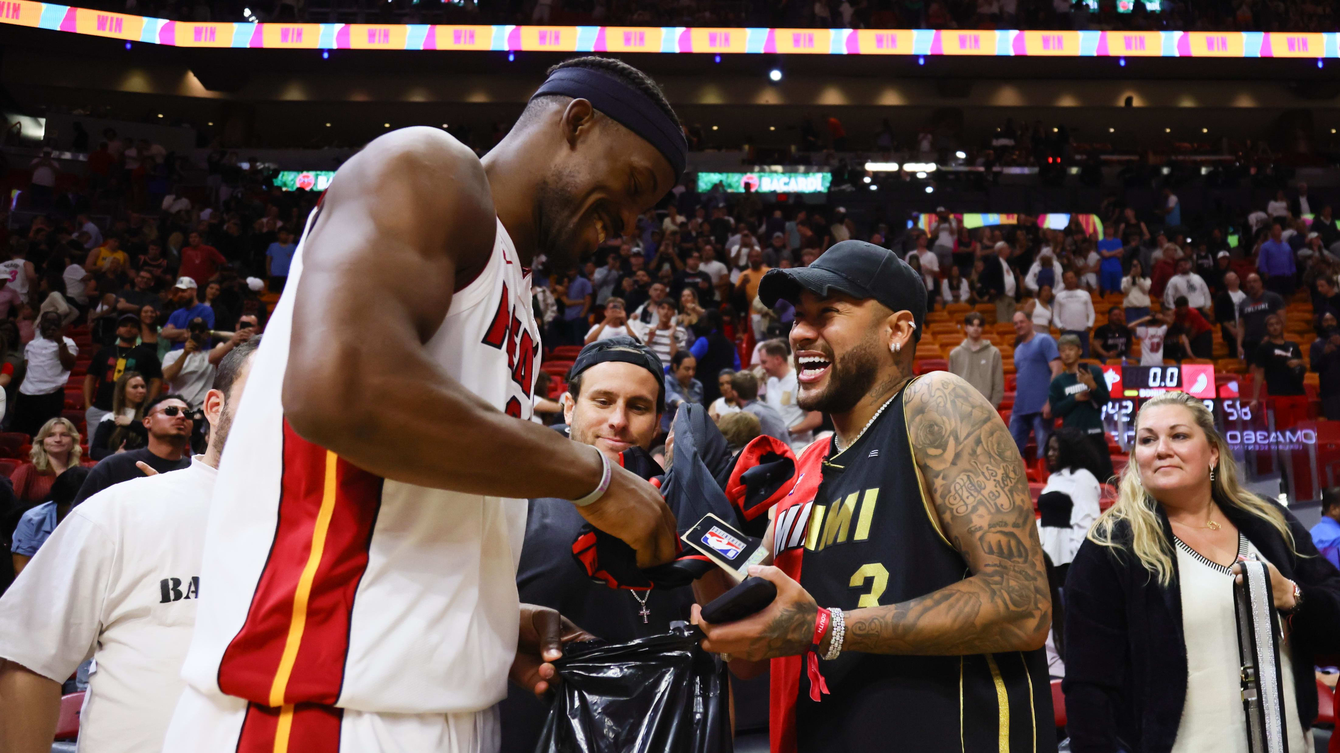 Miami Heat forward Jimmy Butler gives his game-worn shoes to Neymar Jr.