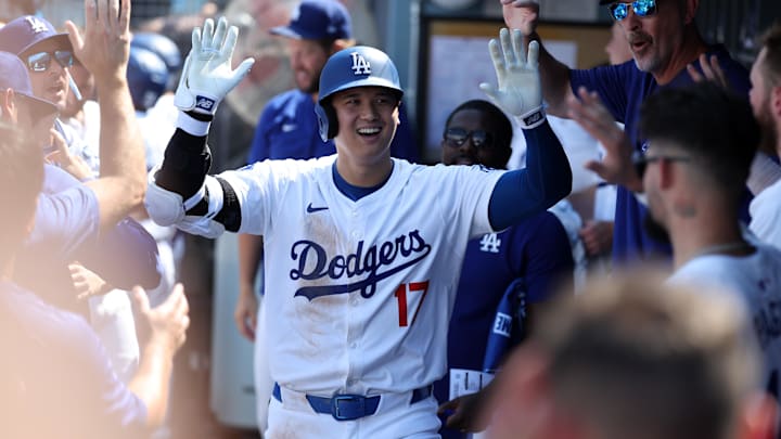 Sep 8, 2024; Los Angeles, California, USA;  Los Angeles Dodgers designated hitter Shohei Ohtani (17) is greeted in the dugout after hitting a home run during the fifth inning against the Cleveland Guardians at Dodger Stadium. Mandatory Credit: Kiyoshi Mio-Imagn Images