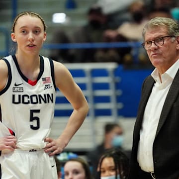 UConn Huskies star Paige Bueckers talks to coach Geno Auriemma on the sidelines.