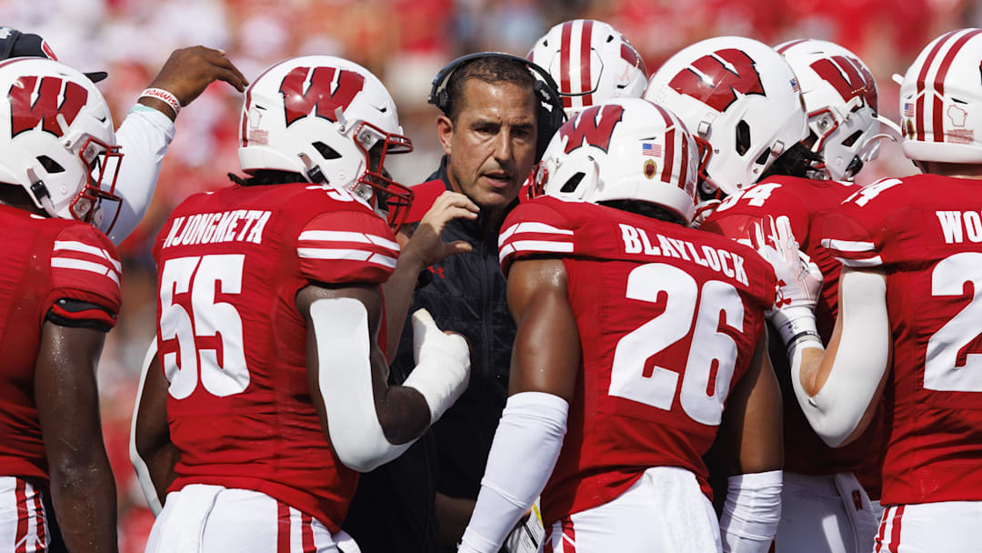 Sep 2, 2023; Madison, Wisconsin, USA;  Wisconsin Badgers head coach Luke Fickell talks in a huddle during the second quarter against the Buffalo Bulls at Camp Randall Stadium. Mandatory Credit: Jeff Hanisch-Imagn Images