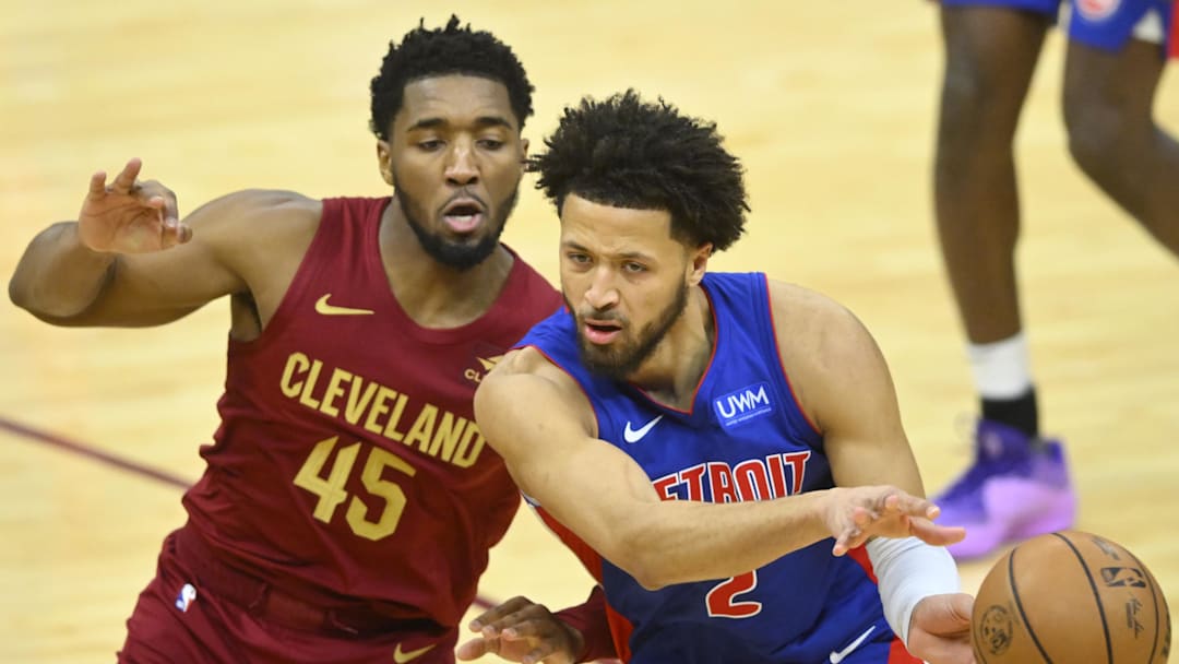 Jan 31, 2024; Cleveland, Ohio, USA; Detroit Pistons guard Cade Cunningham (2) throws a pass beside Cleveland Cavaliers guard Donovan Mitchell (45) in the fourth quarter at Rocket Mortgage FieldHouse. Mandatory Credit: David Richard-Imagn Images