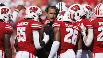Sep 2, 2023; Madison, Wisconsin, USA;  Wisconsin Badgers head coach Luke Fickell talks in a huddle during the second quarter against the Buffalo Bulls at Camp Randall Stadium. Mandatory Credit: Jeff Hanisch-Imagn Images