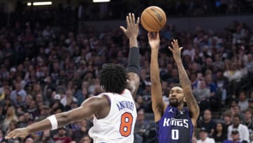 March 16, 2024; Sacramento, California, USA; Sacramento Kings guard Malik Monk (0) shoots the basketball against New York Knicks forward OG Anunoby (8) during the fourth quarter at Golden 1 Center. Mandatory Credit: Kyle Terada-USA TODAY Sports