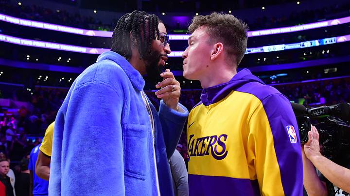 Feb 25, 2025; Los Angeles, California, USA; Dallas Mavericks forward Anthony Davis (left) reacts with Los Angeles Lakers guard Dalton Knecht (right) after the game at Crypto.com Arena. Mandatory Credit: Gary A. Vasquez-Imagn Images