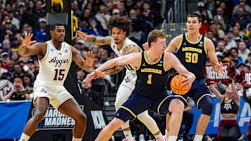Michigan Wolverines center Danny Wolf (1) dribbles the ball into positions against Texas A&M Aggies forward Andersson Garcia (11) during the first half of the second round of the NCAA tournament at Ball Arena in Denver, Colorado, Saturday. March 22, 2025.