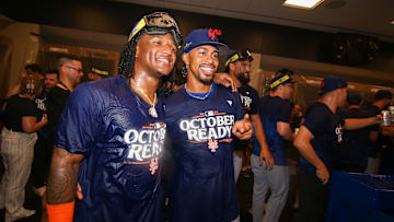 Sep 30, 2024; Atlanta, Georgia, USA; New York Mets shortstop Luisangel Acuna (2) and shortstop Francisco Lindor (12) celebrate clinching a wild card playoff birth after a game against the Atlanta Braves at Truist Park. Mandatory Credit: Brett Davis-Imagn Images
