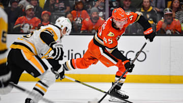 Oct 14, 2025; Anaheim, California, USA; Anaheim Ducks right wing Beckett Sennecke (45) shoots on goal as Pittsburgh Penguins center Noel Acciari (55) moves in during the second period at Honda Center. Mandatory Credit: Gary A. Vasquez-Imagn Images