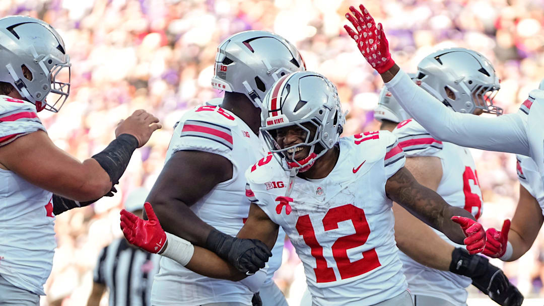 Teammates congratulate Ohio State Buckeyes running back CJ Donaldson (12) after he scored a touchdown during the second half of the NCAA football game against the Washington Huskies at Husky Stadium in Seattle on Sept. 27, 2025. Ohio State won 24-6.