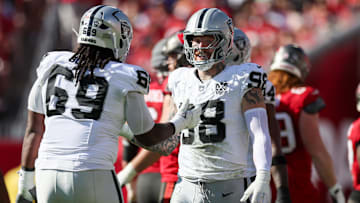 Dec 8, 2024; Tampa, Florida, USA; Las Vegas Raiders defensive end Maxx Crosby (98) and defensive tackle Adam Butler (69) reacts after a play against the Tampa Bay Buccaneers in the second quarter at Raymond James Stadium. Mandatory Credit: Nathan Ray Seebeck-Imagn Images