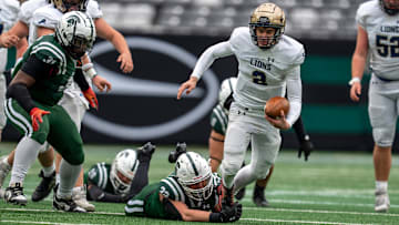 Pope John's Luke Irwin (2) is tripped up by DePaul's Logan Nagle (32) during the NJSIAA Non-Public B high school football championship game between DePaul and Pope John on Friday, Nov. 29 at MetLife Stadium.