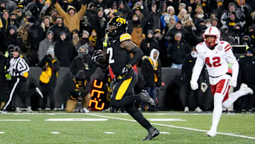 Iowa Hawkeyes running back Kaleb Johnson (2) runs to the endzone to score a touchdown as DUPLICATE***Nebraska Cornhuskers linebacker Mikai Gbayor (42) trails Friday, Nov. 29, 2024 at Kinnick Stadium in Iowa City, Iowa.