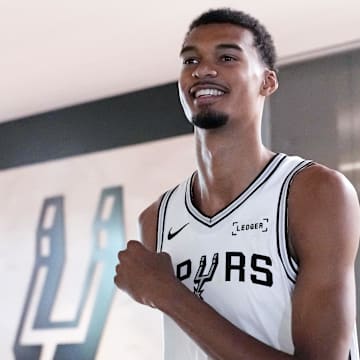 Sep 29, 2025; San Antonio, TX, USA; San Antonio Spurs forward-center Victor Wembanyama (1) enters the court before posing for photos and taking questions during Media Day at Victory Capital Performance Center in San Antonio.