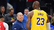 Feb 4, 2025; Inglewood, California, USA; Los Angeles Clippers head coach Tyronn Lue meets with Los Angeles Lakers forward LeBron James (23) before the first half at Intuit Dome. Mandatory Credit: Gary A. Vasquez-Imagn Images