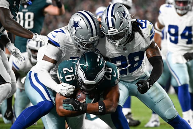 Philadelphia Eagles RB Saquon Barkley carries the ball for a TD defended by Dallas Cowboys CB Trevon Diggs and S Malik Hooker