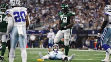 Sep 17, 2023; Arlington, Texas, USA; Dallas Cowboys quarterback Dak Prescott (4) reacts after throwing a touchdown pass as New York Jets defensive end Micheal Clemons (72) looks on in the second quarter