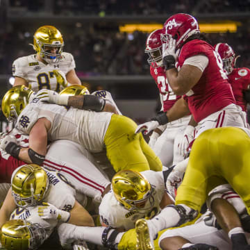 Jan 1, 2021; Arlington, TX, USA; Notre Dame s Kyren Williams, pictured at the bottom of the pile, plows into the end zone for a touchdown during the 2021 College Football Playoff Rose Bowl game on Friday, Jan. 1, 2021, inside AT&T Stadium in Arlington, Texas. 