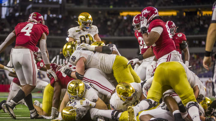 Jan 1, 2021; Arlington, TX, USA; Notre Dame s Kyren Williams, pictured at the bottom of the pile, plows into the end zone for a touchdown during the 2021 College Football Playoff Rose Bowl game on Friday, Jan. 1, 2021, inside AT&T Stadium in Arlington, Texas. 