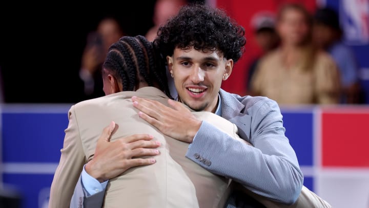 Jun 26, 2024; Brooklyn, NY, USA; Zaccharie Risacher of France hugs fellow French player Alexandre Sarr after being selected first overall by the Atlanta Hawks in the first round of the 2024 NBA Draft at Barclays Center. Mandatory Credit: Brad Penner-USA TODAY Sports