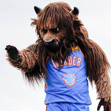 Rumble the Bison waves to children during the Saint Patrick's Day Parade at the Stockyards in Oklahoma City, on Saturday, March 16, 2024.