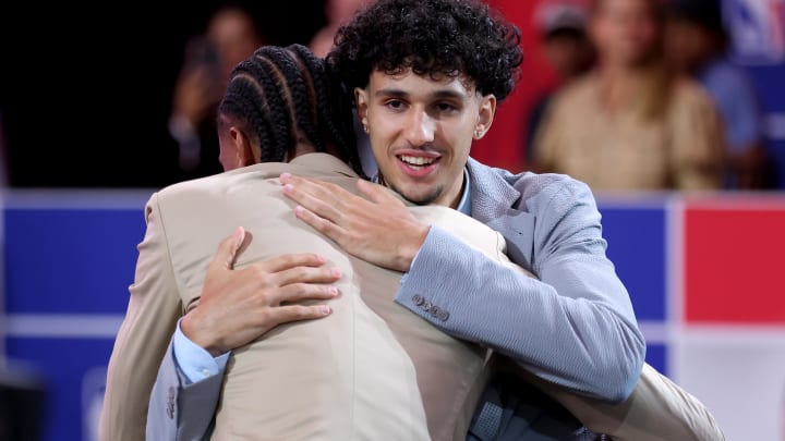 Jun 26, 2024; Brooklyn, NY, USA; Zaccharie Risacher of France hugs fellow French player Alexandre Sarr after being selected first overall by the Atlanta Hawks in the first round of the 2024 NBA Draft at Barclays Center. Mandatory Credit: Brad Penner-USA TODAY Sports