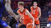 Nov 4, 2024; Champaign, Illinois, USA;  Illinois Fighting Illini guard Kasparas Jakucionis (32) drives the ball during the first half against the Eastern Illinois Panthers at State Farm Center. Mandatory Credit: Ron Johnson-Imagn Images