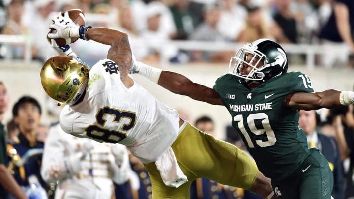 Sep 23, 2017; East Lansing, MI, USA; Notre Dame Fighting Irish wide receiver Chase Claypool (83) catches a pass as Michigan State Spartans cornerback Josh Butler (19) defends in the third quarter at Spartan Stadium. Mandatory Credit: Matt Cashore-USA TODAY Sports