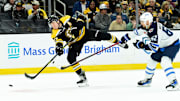 Jan 30, 2025; Boston, Massachusetts, USA; Boston Bruins defenseman Charlie McAvoy (73) shoots the puck while Winnipeg Jets right wing Nino Niederreiter (62) defends during the third period at TD Garden. Mandatory Credit: Bob DeChiara-Imagn Images