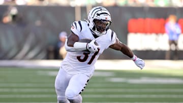 Oct 27, 2024; Cincinnati, Ohio, USA;  Cincinnati Bengals running back Zack Moss (31) runs the ball as Philadelphia Eagles linebacker Zack Baun (53) defends during the third quarter at Paycor Stadium. Mandatory Credit: Joseph Maiorana-Imagn Images