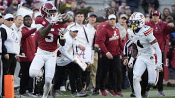 Nov 30, 2024; Tuscaloosa, Alabama, USA;  Alabama Crimson Tide wide receiver Germie Bernard (5) makes a catch for a first down against Auburn Tigers cornerback Kayin Lee (4) during the first half at Bryant-Denny Stadium. Mandatory Credit: Gary Cosby Jr.-Imagn Images