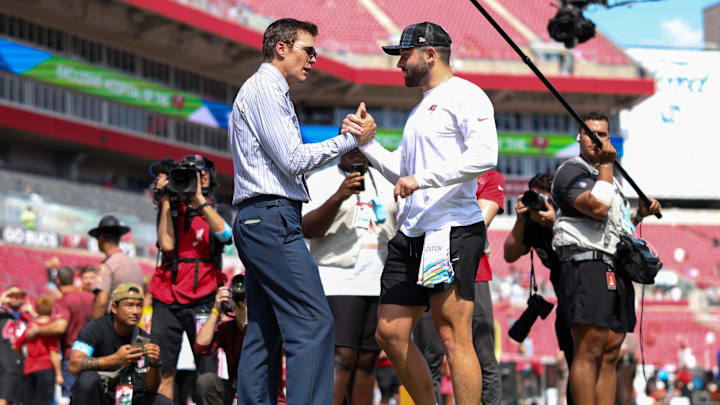 Fox broadcaster and former NFL quarterback Tom Brady speaks to Tampa Bay Buccaneers quarterback Baker Mayfield before Sunday's game against the Philadelphia Eagles at Raymond James Stadium. 