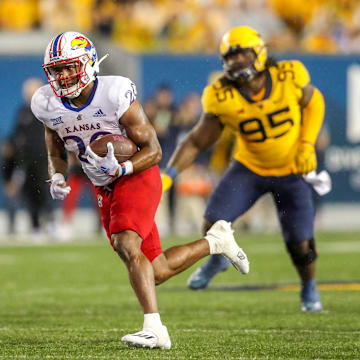 Sep 10, 2022; Morgantown, West Virginia, USA; Kansas Jayhawks running back Daniel Hishaw Jr. (20) runs the ball for a touchdown during the fourth quarter against the West Virginia Mountaineers at Mountaineer Field at Milan Puskar Stadium. Mandatory Credit: Ben Queen-Imagn Images