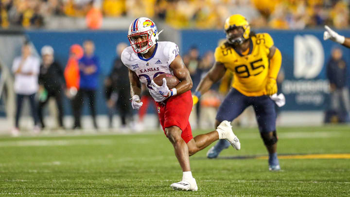 Sep 10, 2022; Morgantown, West Virginia, USA; Kansas Jayhawks running back Daniel Hishaw Jr. (20) runs the ball for a touchdown during the fourth quarter against the West Virginia Mountaineers at Mountaineer Field at Milan Puskar Stadium. Mandatory Credit: Ben Queen-Imagn Images