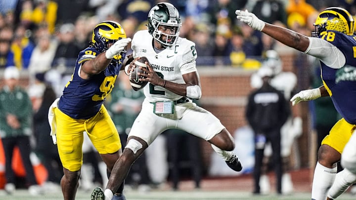 Michigan defensive end Cameron Brandt (91) tackles Michigan State quarterback Aidan Chiles (2) during the second half at Michigan Stadium in Ann Arbor on Saturday, Oct. 26, 2024. Michigan defensive end Cameron Brandt (91) tackles Michigan State quarterback Aidan Chiles (2) during the second half at Michigan Stadium in Ann Arbor on Saturday, Oct. 26, 2024.