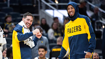 Oct 17, 2024; Indianapolis, Indiana, USA; Indiana Pacers guard T.J. McConnell (9) and  guard Tyrese Haliburton (0) cheer in the second half against the Charlotte Hornets at Gainbridge Fieldhouse. Mandatory Credit: Trevor Ruszkowski-Imagn Images