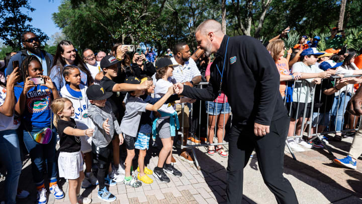 Florida Gators head coach Billy Napier shakes hands with fans