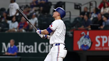 Aug 19, 2024; Arlington, Texas, USA; Texas Rangers shortstop Corey Seager (5) hits a three-run home run against the Pittsburgh Pirates in the third inning at Globe Life Field.