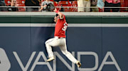Jul 2, 2025; Washington, District of Columbia, USA; Washington Nationals center fielder Jacob Young (30) scales the centerfield wall to rob Detroit Tigers left fielder Riley Greene (31) of a home run during the ninth inning at Nationals Park.
